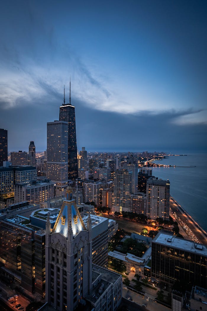 A breathtaking aerial view of Chicago's skyline featuring the iconic John Hancock Center at twilight.